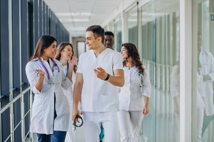 team-young-specialist-doctors-standing-corridor-hospital